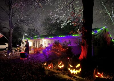 Halloween decor and pumpkins along fence